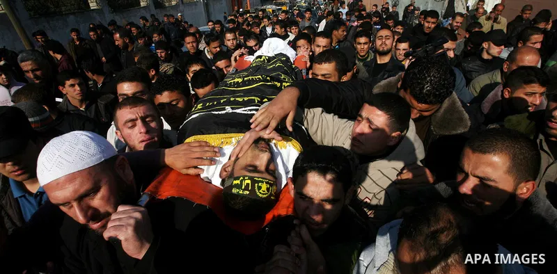 Palestinian mourners carry the body of Islamic Jihad militant Ismail Al-Areer during his funeral in Gaza City on December 7, 2011. A Palestinian was killed and five others were wounded by Israeli air strikes on the Gaza...