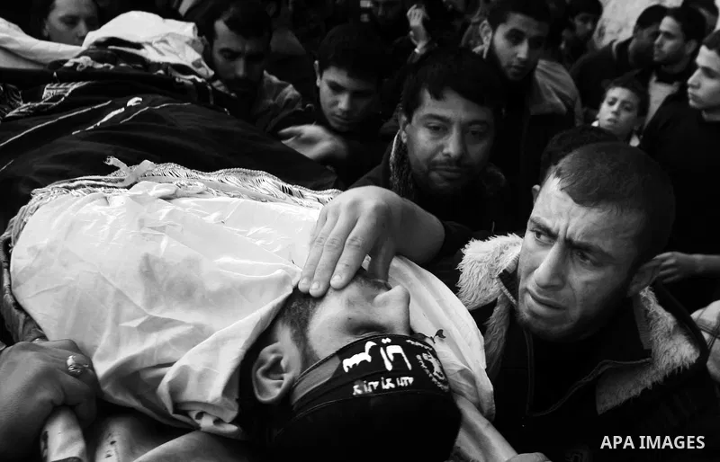 Palestinian mourners carry the body of Islamic Jihad militant Ismail Al-Areer during his funeral in Gaza City on December 7, 2011. A Palestinian was killed and five others were wounded by Israeli air strikes on the Gaza...