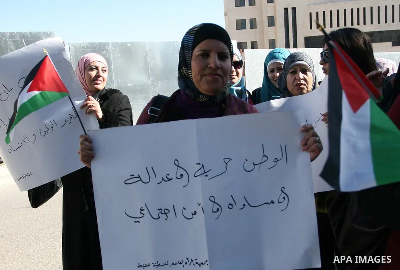 Activists from the Palestinian Working Woman Society for Development (PWWSD) stage a protest next to the Prime Minister office in the West Bank town of Ramallah, 07 December 2011. The protesters called on the Prime Minis...