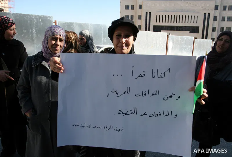 Activists from the Palestinian Working Woman Society for Development (PWWSD) stage a protest next to the Prime Minister office in the West Bank town of Ramallah, 07 December 2011. The protesters called on the Prime Minis...