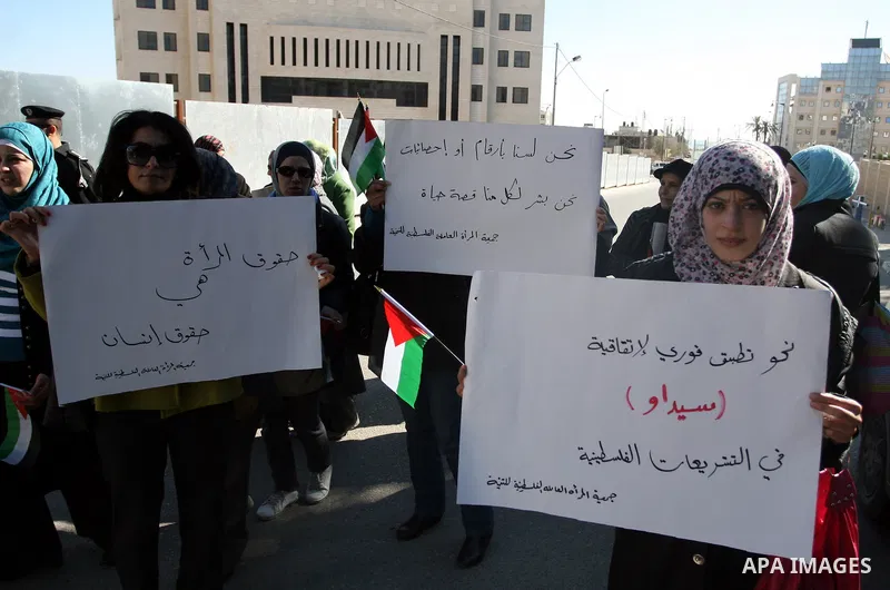 Activists from the Palestinian Working Woman Society for Development (PWWSD) stage a protest next to the Prime Minister office in the West Bank town of Ramallah, 07 December 2011. The protesters called on the Prime Minis...