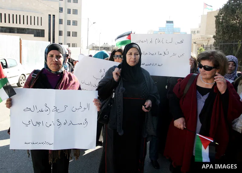 Activists from the Palestinian Working Woman Society for Development (PWWSD) stage a protest next to the Prime Minister office in the West Bank town of Ramallah, 07 December 2011. The protesters called on the Prime Minis...