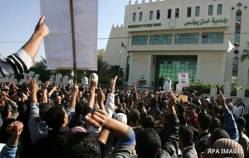Palestinians protest in front of Khan Yunis Municipality headquarters during the funeral of Wesam,5 years, and his sister Malak Sahloul,3 years, in Khan Younis, southern Gaza Strip on December 7, 2011. Wesam and Malak we...
