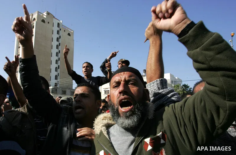 Palestinians protest in front of Khan Yunis Municipality headquarters during the funeral of Wesam,5 years, and his sister Malak Sahloul,3 years, in Khan Younis, southern Gaza Strip on December 7, 2011. Wesam and Malak we...