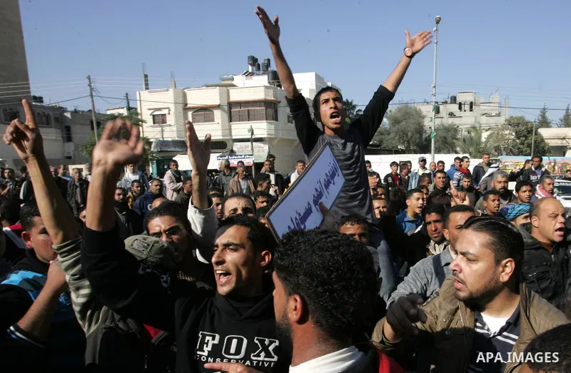 Palestinians protest in front of Khan Yunis Municipality headquarters during the funeral of Wesam,5 years, and his sister Malak Sahloul,3 years, in Khan Younis, southern Gaza Strip on December 7, 2011. Wesam and Malak we...