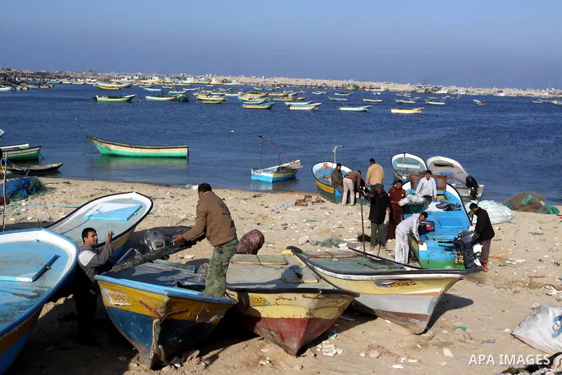Palestinian fishermen work at a seaport in Gaza on Dec. 8, 2011. Israel is turning Gaza's naval borders into imposed facts by marking the area that Palestinian fishermen are allowed to work in, Hamas authorities said on...