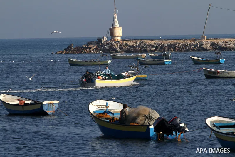 Palestinian fishermen work at a seaport in Gaza on Dec. 8, 2011. Israel is turning Gaza's naval borders into imposed facts by marking the area that Palestinian fishermen are allowed to work in, Hamas authorities said on...