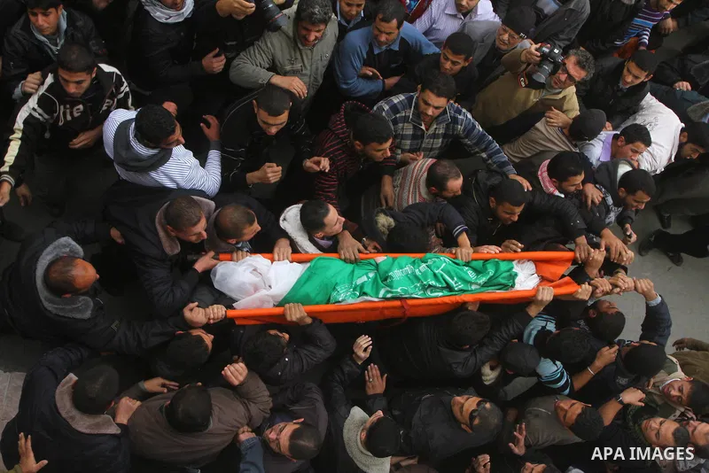 Palestinians carry the bodies of Sobhi al-Batsh, a member of Hamas's armed wing the Ezzedine al-Qassam Brigades, and Issam al-Batsh, a senior member of the Al-Aqsa Martyrs Brigades, mourn outside his home during his fune...