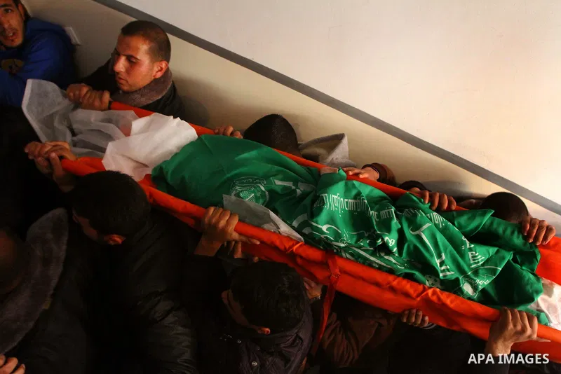 Relative of Palestinians Sobhi al-Batsh, a member of Hamas's armed wing the Ezzedine al-Qassam Brigades, and Issam al-Batsh, a senior member of the Al-Aqsa Martyrs Brigades, mourn at his home during his funeral in Gaza C...