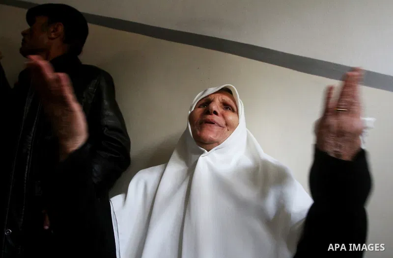 Relative of Palestinians Sobhi al-Batsh, a member of Hamas's armed wing the Ezzedine al-Qassam Brigades, and Issam al-Batsh, a senior member of the Al-Aqsa Martyrs Brigades, mourn at his home during his funeral in Gaza C...