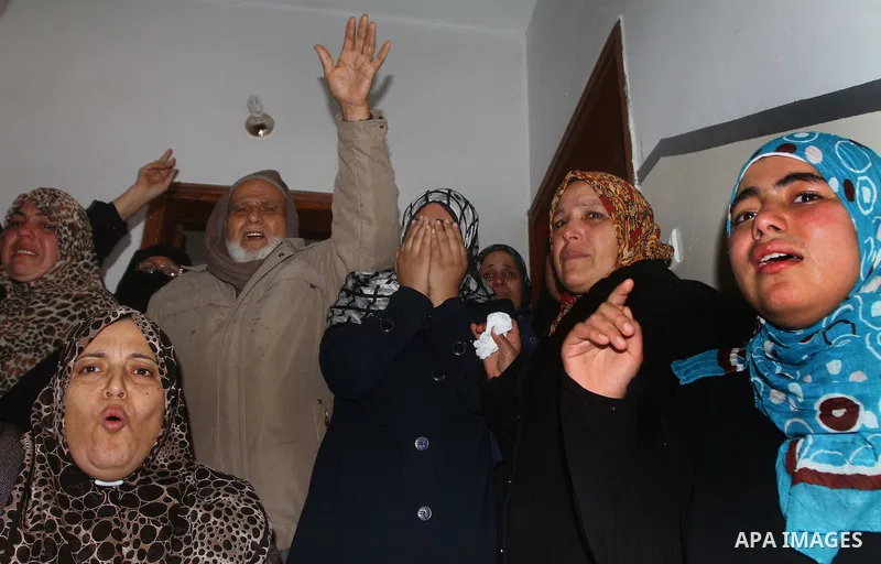 Relative of Palestinians Sobhi al-Batsh, a member of Hamas's armed wing the Ezzedine al-Qassam Brigades, and Issam al-Batsh, a senior member of the Al-Aqsa Martyrs Brigades, mourn at his home during his funeral in Gaza C...