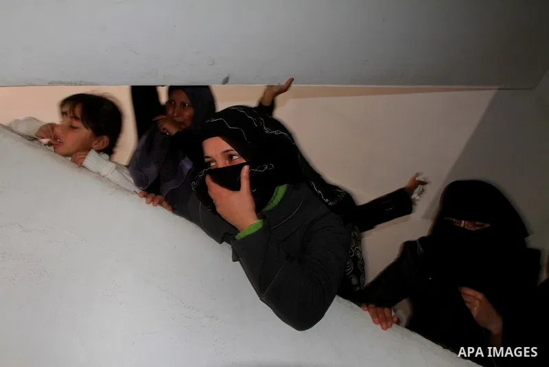 Relative of Palestinians Sobhi al-Batsh, a member of Hamas's armed wing the Ezzedine al-Qassam Brigades, and Issam al-Batsh, a senior member of the Al-Aqsa Martyrs Brigades, mourn at his home during his funeral in Gaza C...