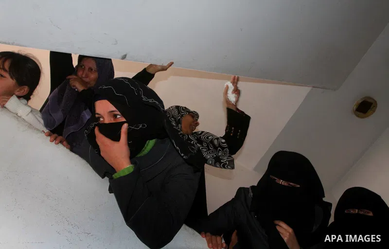 Relative of Palestinians Sobhi al-Batsh, a member of Hamas's armed wing the Ezzedine al-Qassam Brigades, and Issam al-Batsh, a senior member of the Al-Aqsa Martyrs Brigades, mourn at his home during his funeral in Gaza C...