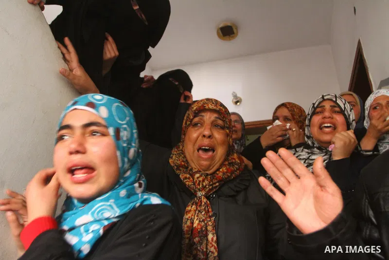 Relative of Palestinians Sobhi al-Batsh, a member of Hamas's armed wing the Ezzedine al-Qassam Brigades, and Issam al-Batsh, a senior member of the Al-Aqsa Martyrs Brigades, mourn at his home during his funeral in Gaza C...