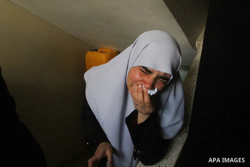 Relative of Palestinians Sobhi al-Batsh, a member of Hamas's armed wing the Ezzedine al-Qassam Brigades, and Issam al-Batsh, a senior member of the Al-Aqsa Martyrs Brigades, mourn at his home during his funeral in Gaza C...