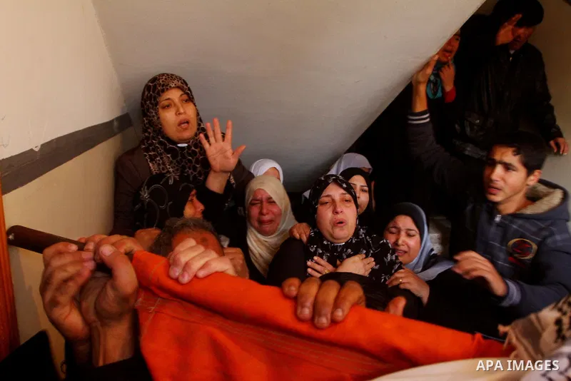 Relative of Palestinians Sobhi al-Batsh, a member of Hamas's armed wing the Ezzedine al-Qassam Brigades, and Issam al-Batsh, a senior member of the Al-Aqsa Martyrs Brigades, mourn at his home during his funeral in Gaza C...