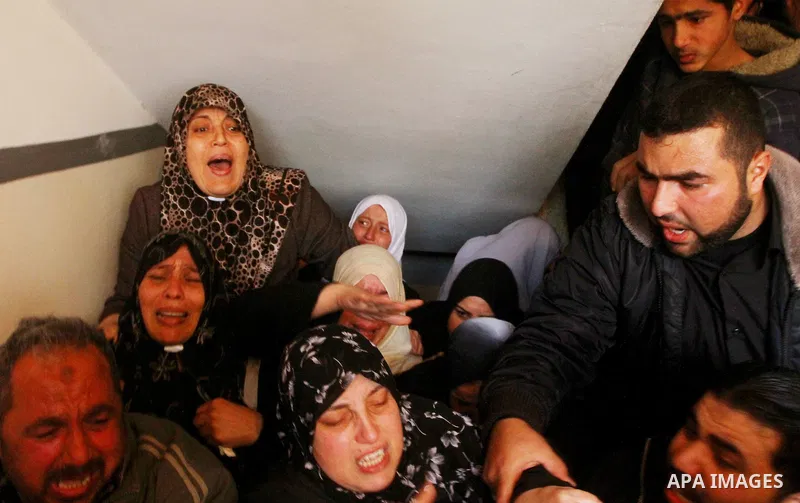 Relative of Palestinians Sobhi al-Batsh, a member of Hamas's armed wing the Ezzedine al-Qassam Brigades, and Issam al-Batsh, a senior member of the Al-Aqsa Martyrs Brigades, mourn at his home during his funeral in Gaza C...