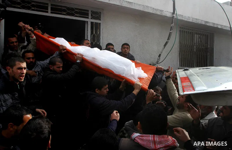 Palestinians carry the bodies of Sobhi al-Batsh, a member of Hamas's armed wing the Ezzedine al-Qassam Brigades, and Issam al-Batsh, a senior member of the Al-Aqsa Martyrs Brigades, outside their home during their funera...
