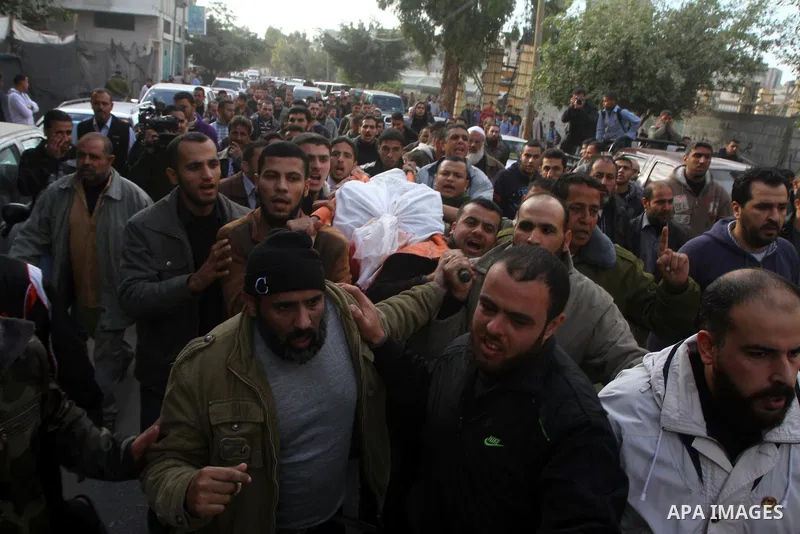 Palestinians carry the bodies of Sobhi al-Batsh, a member of Hamas's armed wing the Ezzedine al-Qassam Brigades, and Issam al-Batsh, a senior member of the Al-Aqsa Martyrs Brigades, outside their home during their funera...