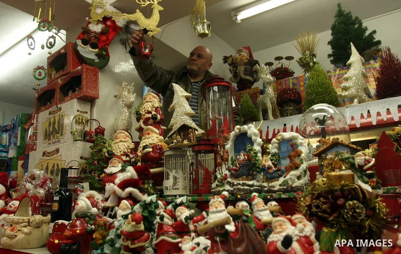 A Palestinian vendor displays products for Christmas Day at his shop, in Jerusalem's old city, Thursday, on Dec. 8, 2011. Christians Pilgrims and tourists are expected to visit Bethlehem, the alleged birthplace of Jesus...