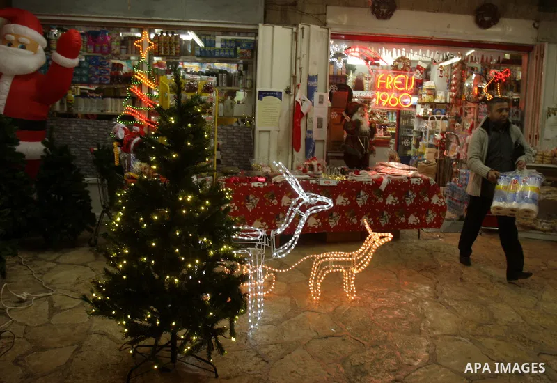 A Palestinian vendor displays products for Christmas Day at his shop, in Jerusalem's old city, Thursday, on Dec. 8, 2011. Christians Pilgrims and tourists are expected to visit Bethlehem, the alleged birthplace of Jesus...