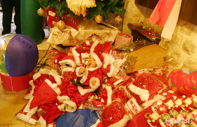 A Palestinian vendor displays products for Christmas Day at his shop, in Jerusalem's old city, Thursday, on Dec. 8, 2011. Christians Pilgrims and tourists are expected to visit Bethlehem, the alleged birthplace of Jesus...