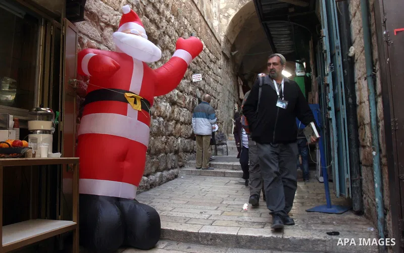 A Palestinian vendor displays products for Christmas Day at his shop, in Jerusalem's old city, Thursday, on Dec. 8, 2011. Christians Pilgrims and tourists are expected to visit Bethlehem, the alleged birthplace of Jesus...