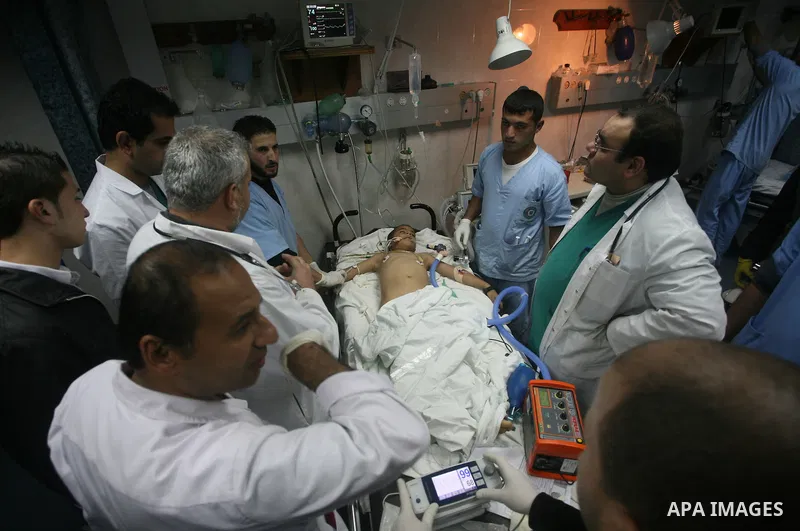 Palestinian doctors care for a wounded boy at al-Shifa hospital in Gaza City on December 9, 2011, after an Israeli air strike killed at least one Palestinians and wounded others, Palestinian medical and security sources...