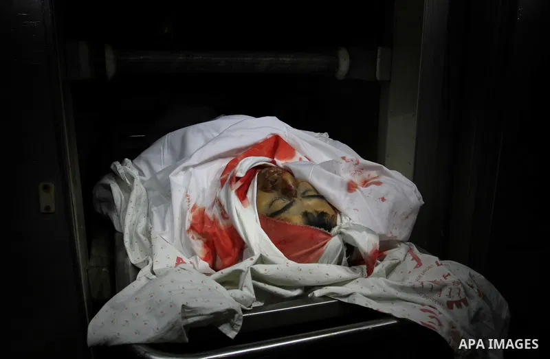 The body of Bahjat al-Zalan, 36, is seen inside the mourgue at al-Shifa hospital in Gaza City on December 9, 2011. Al-Zalan was killed after an Israeli air strike. Photo by Mahmud Nassar