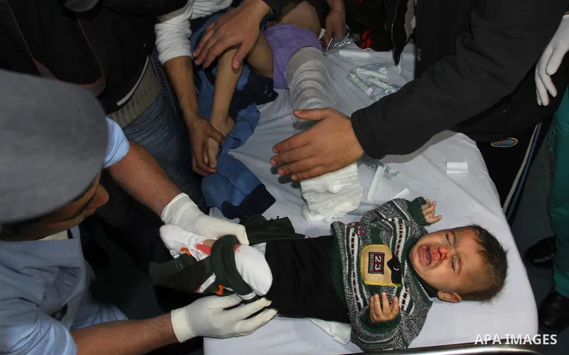 Palestinian doctors care for a wounded boy at al-Shifa hospital in Gaza City on December 9, 2011, after an Israeli air strike killed at least one Palestinians and wounded others, Palestinian medical and security sources...