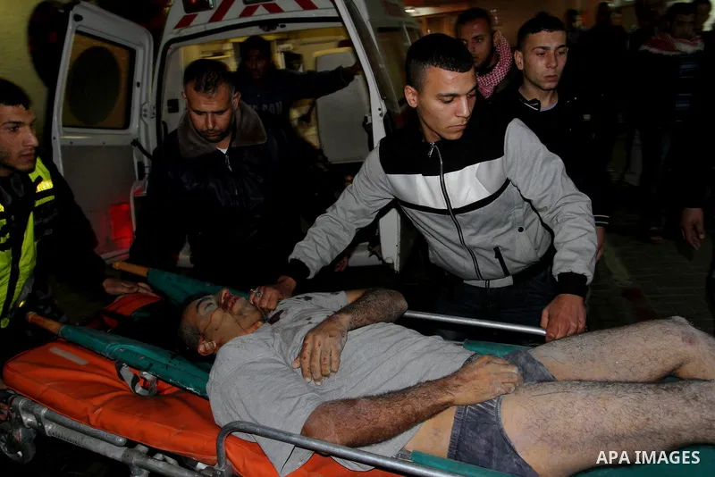 Palestinian men wheel a wounded man on a stretcher into al-Shifa hospital in Gaza City on 09 December 2011. An Israeli air strike killed at least one Palestinian and wounded others, Palestinian medical and security sourc...