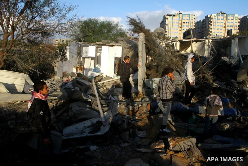 Palestinians inspect a destroyed house in Gaza city on December 9, 2011. Violence across the Israeli-Gaza border escalated on Friday with Israeli air strikes killing at least three people and Palestinian militants firing...