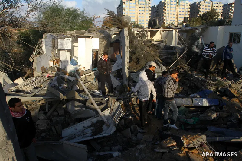 Palestinians inspect a destroyed house in Gaza city on December 9, 2011. Violence across the Israeli-Gaza border escalated on Friday with Israeli air strikes killing at least three people and Palestinian militants firing...