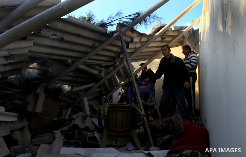 Palestinians inspect a destroyed house in Gaza city on December 9, 2011. Violence across the Israeli-Gaza border escalated on Friday with Israeli air strikes killing at least three people and Palestinian militants firing...