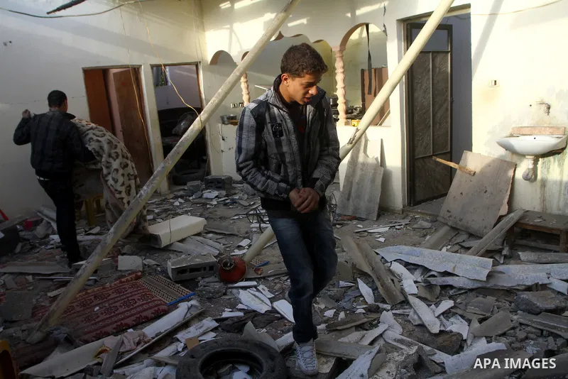 Palestinians inspect a destroyed house in Gaza city on December 9, 2011. Violence across the Israeli-Gaza border escalated on Friday with Israeli air strikes killing at least three people and Palestinian militants firing...