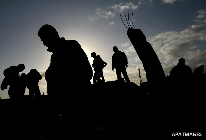 Palestinians survey the site of a Hamas training camp after it was hit in an Israeli air strike in Gaza City on December 9, 2011. Violence across the Israeli-Gaza border escalated on Friday with Israeli air strikes killi...