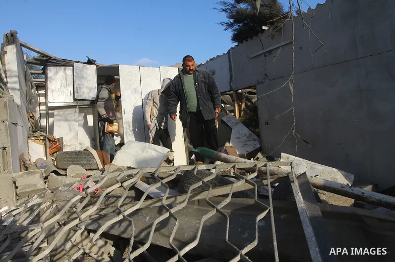 Palestinians inspect a destroyed house in Gaza city on December 9, 2011. Violence across the Israeli-Gaza border escalated on Friday with Israeli air strikes killing at least three people and Palestinian militants firing...