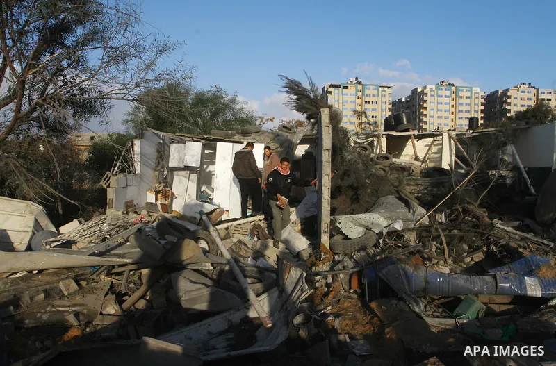 Palestinians inspect a destroyed house in Gaza city on December 9, 2011. Violence across the Israeli-Gaza border escalated on Friday with Israeli air strikes killing at least three people and Palestinian militants firing...