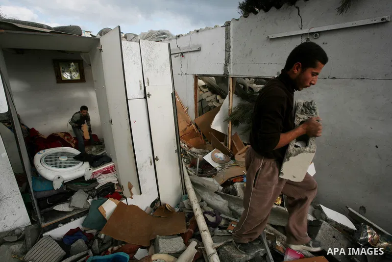 Palestinians inspect a destroyed house in Gaza city on December 9, 2011. Violence across the Israeli-Gaza border escalated on Friday with Israeli air strikes killing at least three people and Palestinian militants firing...
