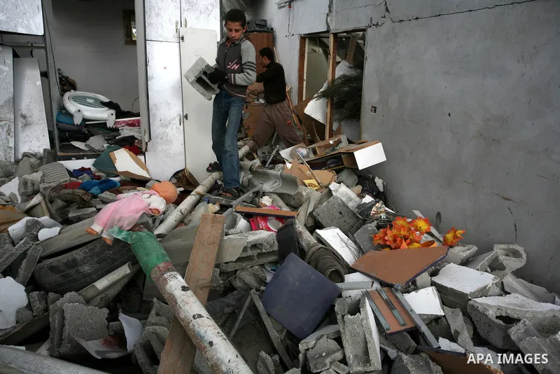 Palestinians inspect a destroyed house in Gaza city on December 9, 2011. Violence across the Israeli-Gaza border escalated on Friday with Israeli air strikes killing at least three people and Palestinian militants firing...