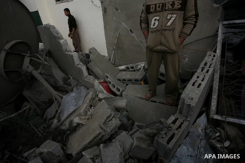 Palestinians inspect a destroyed house in Gaza city on December 9, 2011. Violence across the Israeli-Gaza border escalated on Friday with Israeli air strikes killing at least three people and Palestinian militants firing...