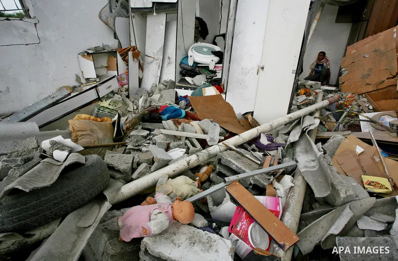 Palestinians inspect a destroyed house in Gaza city on December 9, 2011. Violence across the Israeli-Gaza border escalated on Friday with Israeli air strikes killing at least three people and Palestinian militants firing...