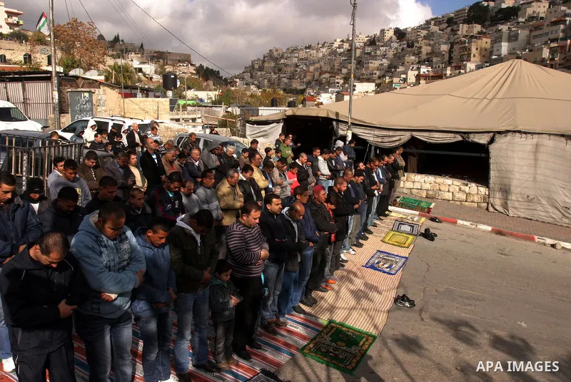 Palestinians attend Friday prayers at the protest tent in the Silwan neighborhood in East Jerusalem on Dec. 9,2011 as Palestinian protesters gather for a demonstration. Photo by Mahfouz Abu Turk