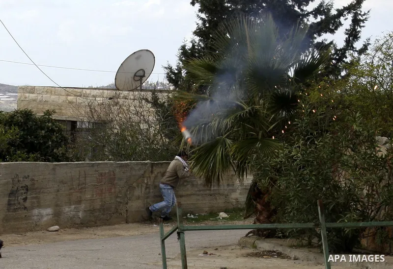 Israeli soldiers fire tear gas towards Palestinian protesters during clashes that broke out at a weekly demonstration against Israeli-occupation in the northern West Bank village of Kfar Kadum on December 9, 2011. A Pale...
