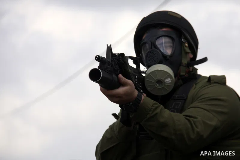 Israeli soldiers fire tear gas towards Palestinian protesters during clashes that broke out at a weekly demonstration against Israeli-occupation in the northern West Bank village of Kfar Kadum on December 9, 2011. A Pale...