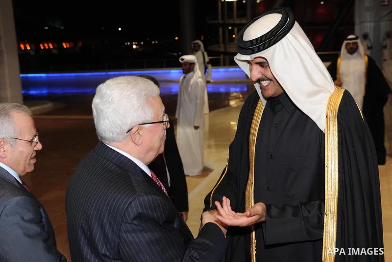 Palestinian President Mahmoud Abbas (Abu Mazen) and Qatari Crown Prince Sheikh Tamim bin Hamad bin Khalifa al-Thani applaud during the opening ceremony of the pan-Arab Games in Doha on December 9, 2011. More than 5,000 A...