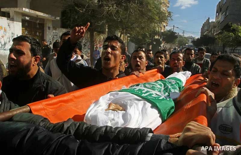 Palestinians carry the body of Ramadan Al Zalan, 12, at his family house during his funeral in Al Shatea refugee camp in the west of Gaza City on, 10 December 2011. Ramadan was injured yesterday and his father Bahjat Al...