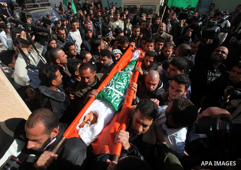 Palestinians carry the body of Ramadan Al Zalan, 12, at his family house during his funeral in Al Shatea refugee camp in the west of Gaza City on, 10 December 2011. Ramadan was injured yesterday and his father Bahjat Al...