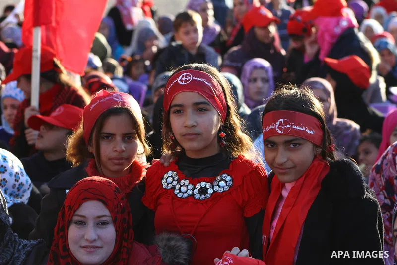 Palestinian supporters of the Popular Front for the Liberation of Palestine (PLFP) wave the group's red flags during a rally held in the northern Gaza Strip town of Beit Lahia on December 10, 2011 to its 44th anniversary...