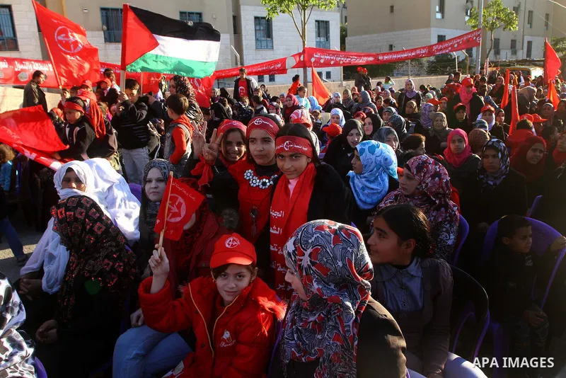 Palestinian supporters of the Popular Front for the Liberation of Palestine (PLFP) wave the group's red flags during a rally held in the northern Gaza Strip town of Beit Lahia on December 10, 2011 to its 44th anniversary...